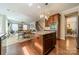 Open concept kitchen with center island, stainless steel appliances, granite countertops, and hardwood floors at 2108 Clarion Dr, Fort Mill, SC 29707