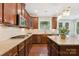 Modern kitchen with granite countertops, stainless steel appliances, and dark wood cabinets at 2108 Clarion Dr, Fort Mill, SC 29707