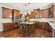 A kitchen showcasing dark wooden cabinets, an island with seating, and stainless steel appliances at 2108 Clarion Dr, Fort Mill, SC 29707