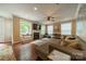 Bright living room with large windows, fireplace, and comfortable seating area with hardwood floors at 2108 Clarion Dr, Fort Mill, SC 29707