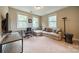 A living room with a beige couch, a desk and multiple windows at 2108 Clarion Dr, Fort Mill, SC 29707