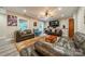 Cozy living room with plush leather seating, a large screen television, and natural lighting at 2108 Clarion Dr, Fort Mill, SC 29707