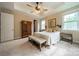 Comfortable main bedroom with a ceiling fan, bedside tables, and a view to the exterior at 2108 Clarion Dr, Fort Mill, SC 29707