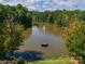 Scenic aerial view of a community pond with a fountain surrounded by lush greenery at 2108 Clarion Dr, Fort Mill, SC 29707