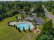 Aerial view of a community pool with a hot tub, fire pit, playground and lake at 2108 Clarion Dr, Fort Mill, SC 29707
