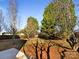 A spacious backyard surrounded by mature trees and a wooden fence offering privacy at 215 Madelia Pl, Mooresville, NC 28115