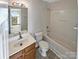 Upstairs bathroom with updated vanity, mirror, toilet, and tub with shower in this home at 215 Madelia Pl, Mooresville, NC 28115