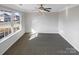 Bright, spacious bedroom with neutral walls and carpet, highlighted by a large window offering a neighborhood view at 215 Madelia Pl, Mooresville, NC 28115