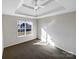 Bright, spacious bedroom with neutral walls and carpet, highlighted by a large window offering a view of the outdoors at 215 Madelia Pl, Mooresville, NC 28115