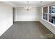 Formal dining room featuring wainscoting, chandelier, and large window for natural light at 215 Madelia Pl, Mooresville, NC 28115