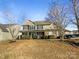 Charming two-story home featuring a blend of stone and siding, complemented by mature trees and manicured landscaping at 215 Madelia Pl, Mooresville, NC 28115