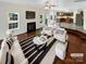 Bright living room with a fireplace, seamlessly connecting to the kitchen through an open-concept design at 215 Madelia Pl, Mooresville, NC 28115