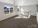 Upstairs loft space with lots of natural light and neutral walls with carpet at 215 Madelia Pl, Mooresville, NC 28115