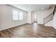 Bright living room with wood floors, a staircase, and windows offering natural light and views at 2260 Hedgecliff Rd # 163, Kannapolis, NC 28025