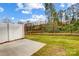 Private fenced backyard features lush green grass and tree views from the concrete patio of this lovely property at 2280 Hedgecliff Rd, Kannapolis, NC 28025
