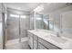 Well-lit bathroom featuring a double vanity, large mirror, and tiled shower with glass doors at 2280 Hedgecliff Rd, Kannapolis, NC 28025