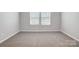 Cozy bedroom with carpet floors, neutral walls, and a window for natural light at 2280 Hedgecliff Rd, Kannapolis, NC 28025