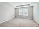 An empty bedroom with neutral carpet, white walls, and a window with blinds at 2280 Hedgecliff Rd, Kannapolis, NC 28025