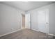 Neutral bedroom featuring carpet floors, a closet and a door that leads to the living area at 2280 Hedgecliff Rd, Kannapolis, NC 28025