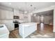 Open kitchen view with large island, white cabinets, and stainless steel appliances at 2280 Hedgecliff Rd, Kannapolis, NC 28025