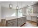 Bright kitchen features an island, stainless appliances, and sliding glass doors to the outside at 2280 Hedgecliff Rd, Kannapolis, NC 28025