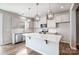 Modern kitchen featuring stainless steel appliances, white cabinetry, and a center island at 2280 Hedgecliff Rd, Kannapolis, NC 28025