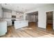 A bright kitchen with stainless steel appliances and an island, open to the rest of the house at 2280 Hedgecliff Rd, Kannapolis, NC 28025