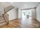 Spacious open-concept living area with hardwood floors and abundant natural light, next to stairs at 2280 Hedgecliff Rd, Kannapolis, NC 28025