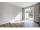 A bright room features hardwood floors, a sliding glass door, and white walls at 2280 Hedgecliff Rd, Kannapolis, NC 28025