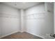 Walk-in closet featuring carpet floors and multiple metal shelving units for storage at 2280 Hedgecliff Rd, Kannapolis, NC 28025