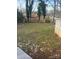 Spacious backyard with a lush green lawn, surrounded by a wooden fence and mature trees at 2404 Booker Ave, Charlotte, NC 28216