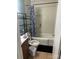 Bathroom features modern fixtures, shower-tub combination, shelving, and vanity at 2404 Booker Ave, Charlotte, NC 28216
