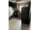 Functional kitchen featuring neutral floors, black appliances, cabinets, and natural light at 2404 Booker Ave, Charlotte, NC 28216