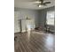 Bright living room featuring wood-look floors, neutral walls, natural light, and a modern ceiling fan at 2404 Booker Ave, Charlotte, NC 28216
