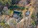 Aerial view of a home featuring a detached garage, raised garden beds, and mature trees at 246 Jerry Crump Rd, Lincolnton, NC 28092