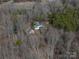Aerial view of home nestled in a mature tree lined lot with detached garage at 246 Jerry Crump Rd, Lincolnton, NC 28092
