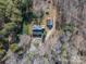 A birds-eye view of the property, featuring a home with a detached garage and surrounded by trees at 246 Jerry Crump Rd, Lincolnton, NC 28092