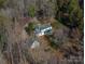 Aerial view of home featuring mature trees, landscaped yard, and detached garage at 246 Jerry Crump Rd, Lincolnton, NC 28092
