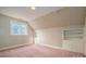 Bright bedroom featuring a window, built-in shelves, pink carpet, and vintage wallpaper at 246 Jerry Crump Rd, Lincolnton, NC 28092