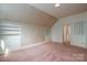 Angled bedroom featuring built-in shelves, pink carpet, and floral wallpaper at 246 Jerry Crump Rd, Lincolnton, NC 28092