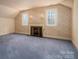 Cozy bedroom with fireplace, floral wallpaper, and carpeted floor at 246 Jerry Crump Rd, Lincolnton, NC 28092
