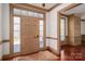 Entryway with a glass paneled front door, wooden floors, and custom trim at 246 Jerry Crump Rd, Lincolnton, NC 28092