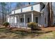 Charming home featuring a covered porch, white columns, and beautiful landscaping at 246 Jerry Crump Rd, Lincolnton, NC 28092
