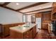 Large kitchen with central island, wood beam ceilings, and hardwood floors at 246 Jerry Crump Rd, Lincolnton, NC 28092