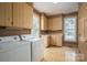 Functional laundry room with washer, dryer, sink, and ample cabinet space at 246 Jerry Crump Rd, Lincolnton, NC 28092