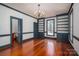 Elegant living room with built-in shelving, wainscoting, chandelier, and large windows at 246 Jerry Crump Rd, Lincolnton, NC 28092