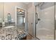 Granite countertop and walk-in shower enhance this well-lit primary bathroom at 258 Lagoda Dr, Locust, NC 28097