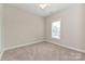 A cozy bedroom offers neutral walls, carpet, and a bright window at 258 Lagoda Dr, Locust, NC 28097