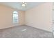 A sunny bedroom features plush carpeting and a classic arched window at 258 Lagoda Dr, Locust, NC 28097
