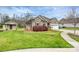 Well-maintained home showcasing lush greenery, a storage shed, and a brick facade at 258 Lagoda Dr, Locust, NC 28097